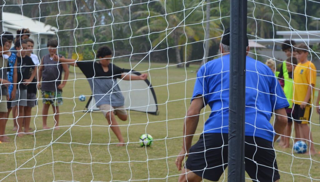 An Apii Te Uki Ou student tries to score with Wynton Rufer in goal. 22111309