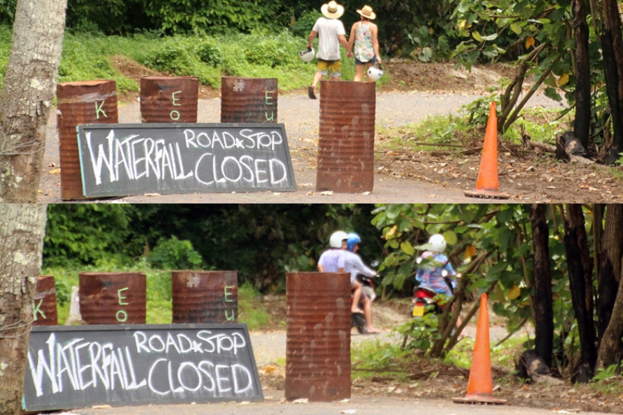 Tourists ignore road closure sign